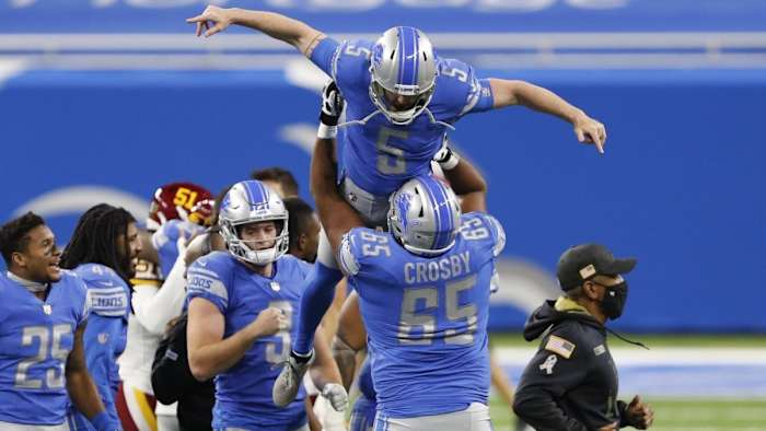Ex-Lions kicker Matt Prater is lifted up in the air by Crosby, after making the game-winning field goal against the Washington Football Team.